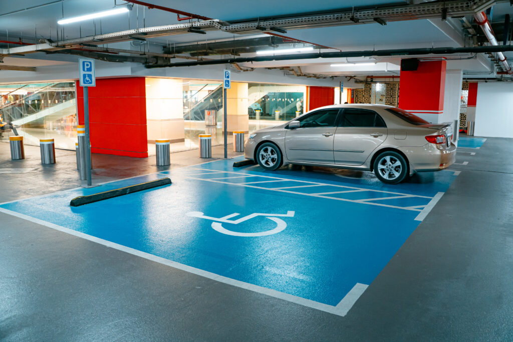 ADA-compliant accessible parking spaces with marked access aisles at hospital entrance.
